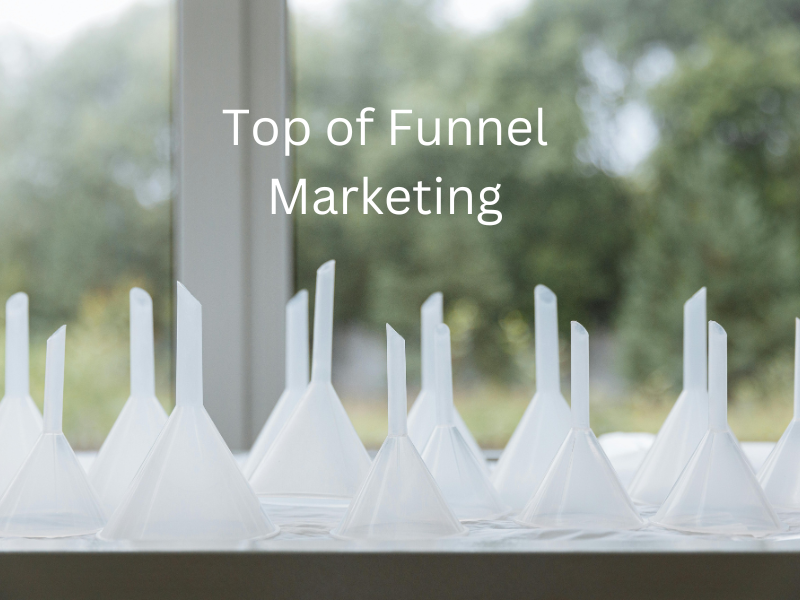 Image showcasing an array of funnels, symbolizing the diverse channels and strategies of top-of-funnel marketing. Each funnel represents a unique approach, capturing the essence of broad outreach and engagement in the early stages of the customer journey. The visual emphasizes the exciting variety and potential for audience interaction at the top of the marketing funnel.